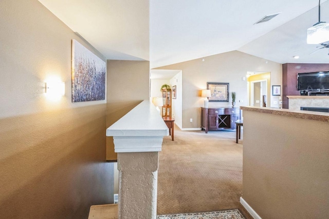 interior space featuring lofted ceiling and light carpet