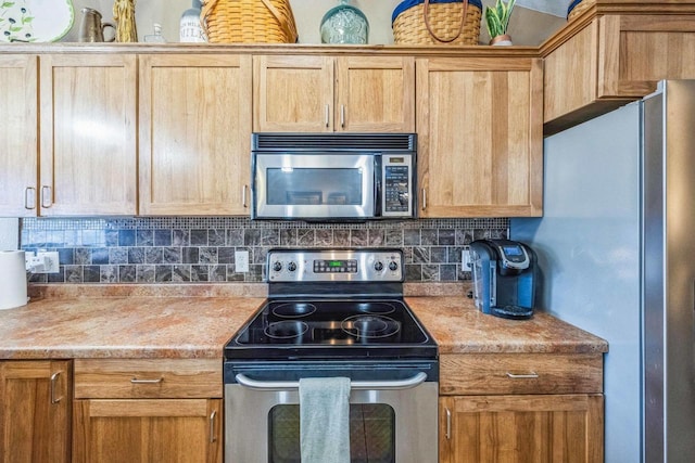 kitchen featuring appliances with stainless steel finishes and tasteful backsplash