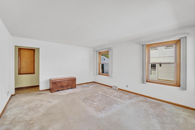 spare room featuring light colored carpet