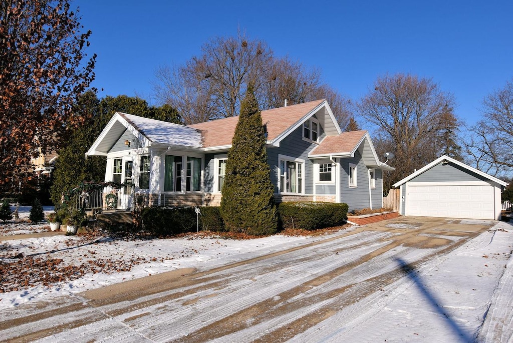 view of front of property featuring a garage and an outbuilding