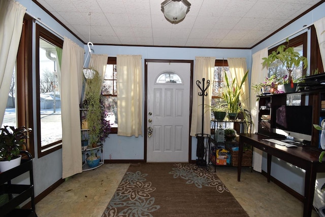 foyer featuring a wealth of natural light and ornamental molding