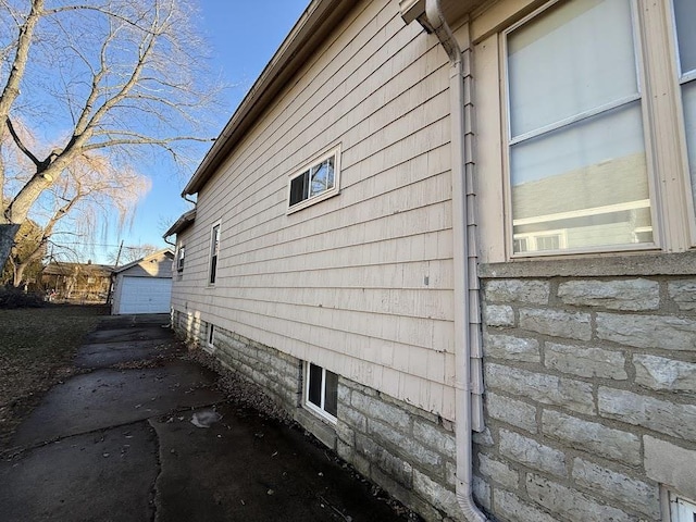 view of side of home featuring an outdoor structure and a garage