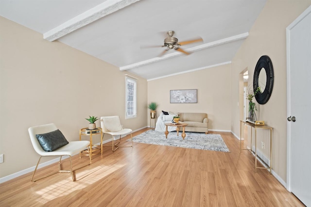 sitting room with ceiling fan, light hardwood / wood-style floors, and lofted ceiling with beams