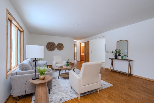 living room featuring a wealth of natural light and hardwood / wood-style flooring