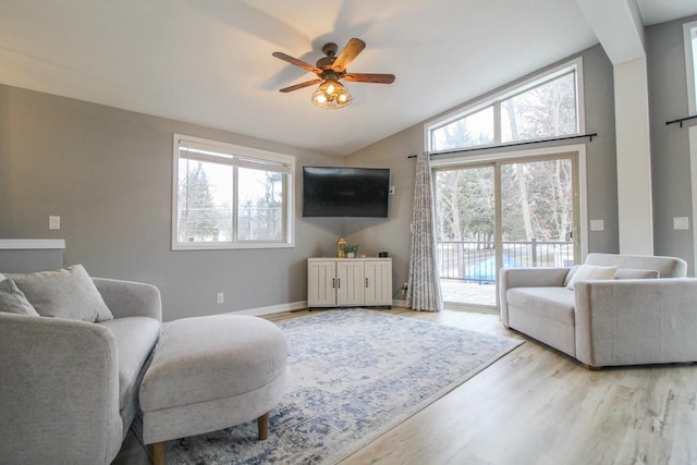 living room with vaulted ceiling, ceiling fan, and light hardwood / wood-style floors