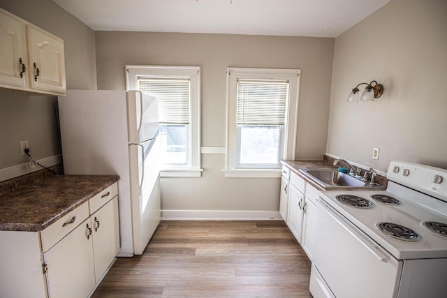 kitchen featuring light hardwood / wood-style floors, sink, white appliances, and white cabinets