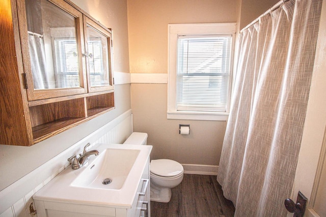 bathroom featuring toilet, hardwood / wood-style floors, and vanity