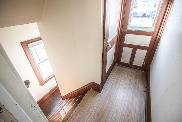 hallway with hardwood / wood-style flooring