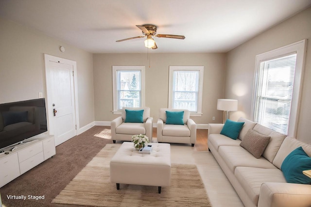 living room featuring ceiling fan, a healthy amount of sunlight, and carpet floors