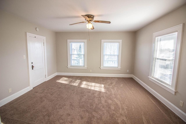 carpeted empty room featuring ceiling fan