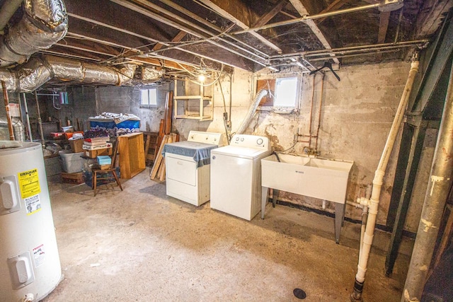 basement with water heater, plenty of natural light, sink, and separate washer and dryer