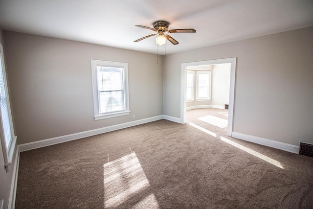 empty room featuring ceiling fan and carpet floors