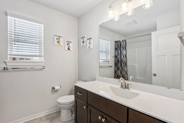 bathroom with toilet, tile patterned flooring, walk in shower, and vanity