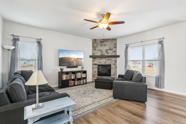 living room with ceiling fan, a fireplace, and hardwood / wood-style floors