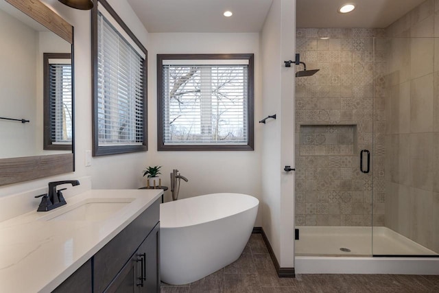 bathroom featuring shower with separate bathtub, tile patterned floors, and vanity