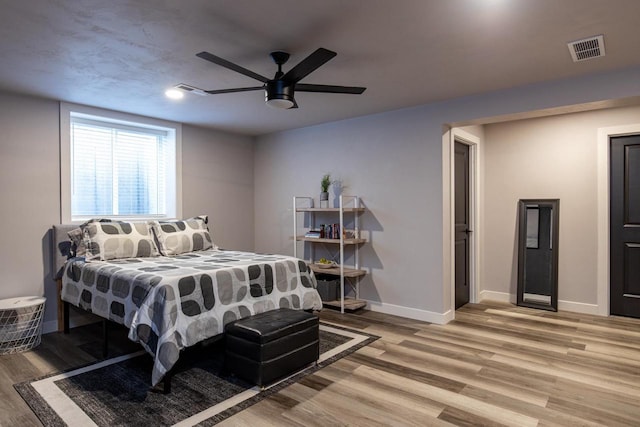 bedroom featuring ceiling fan and light hardwood / wood-style flooring