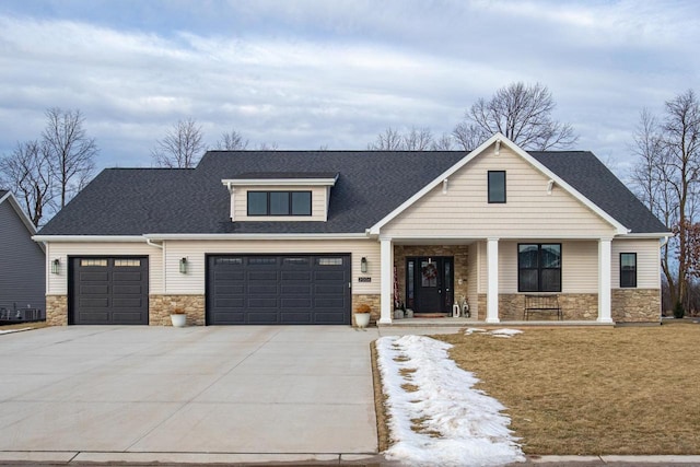 view of front of home featuring a porch and a garage