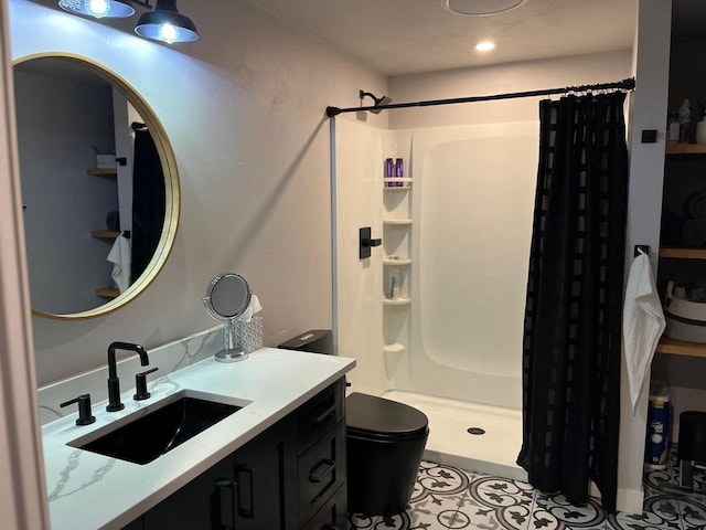 bathroom featuring toilet, tile patterned floors, walk in shower, and vanity