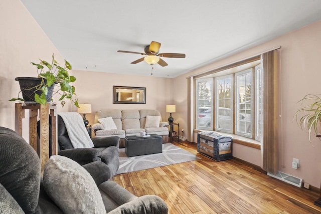 living room featuring ceiling fan and light hardwood / wood-style floors