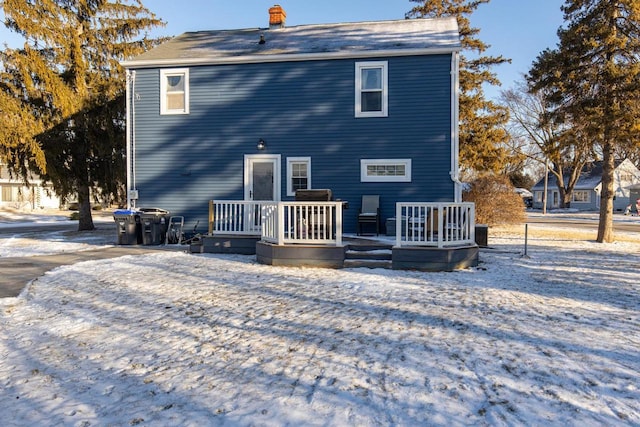 snow covered property featuring a deck