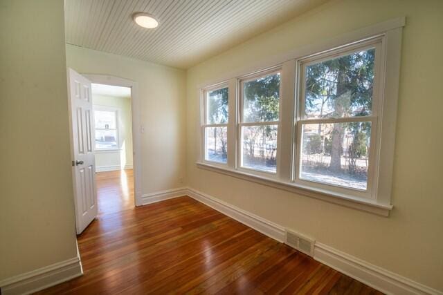 spare room featuring dark hardwood / wood-style flooring