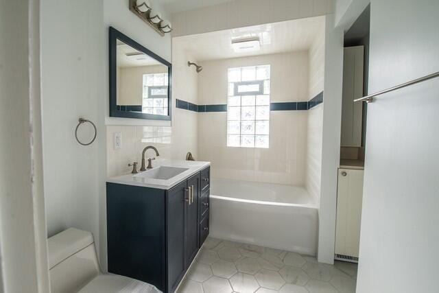 full bathroom featuring tub / shower combination, toilet, and vanity