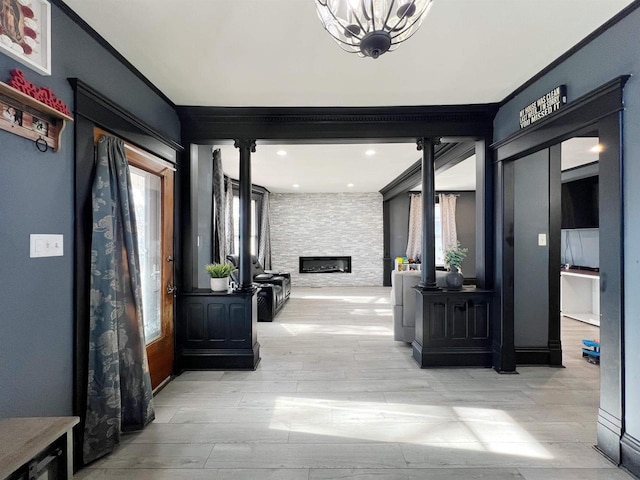 hall featuring ornamental molding and a chandelier