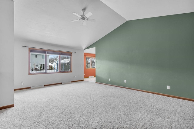 interior space with lofted ceiling, ceiling fan, and carpet floors