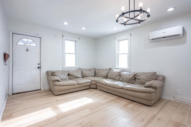 unfurnished living room with an AC wall unit and light hardwood / wood-style floors