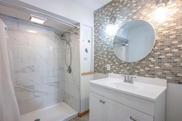 bathroom featuring vanity, backsplash, and walk in shower