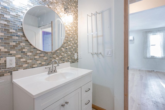 bathroom with tasteful backsplash, vanity, and hardwood / wood-style floors