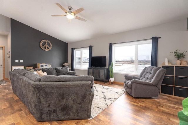 living room featuring ceiling fan, lofted ceiling, and hardwood / wood-style floors