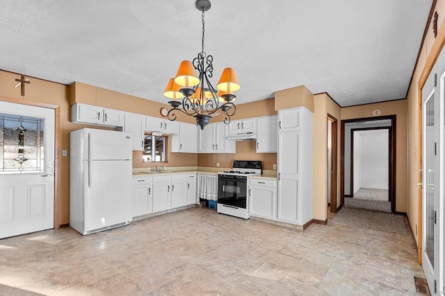 kitchen with white cabinets, sink, white appliances, and a chandelier