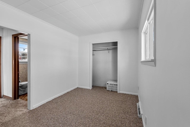 unfurnished bedroom featuring carpet floors and a closet