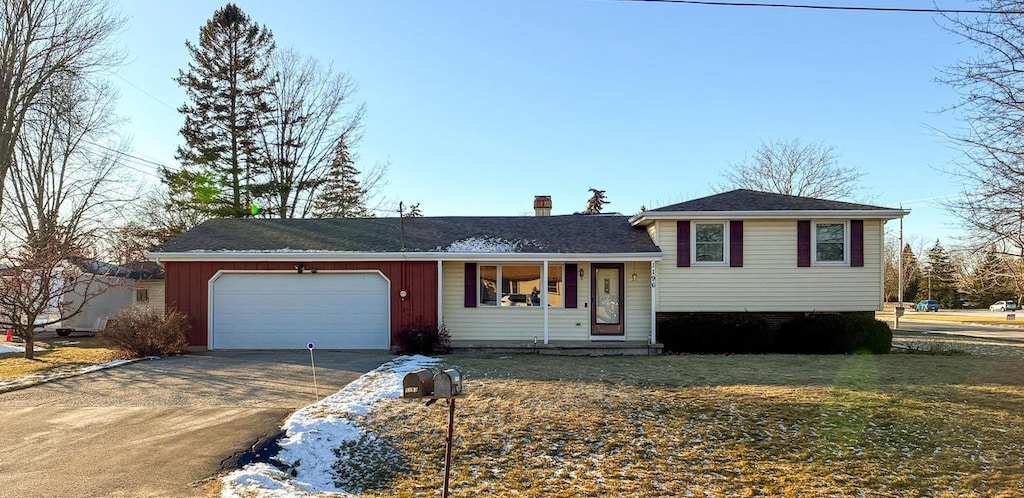 split level home featuring a front lawn and a garage