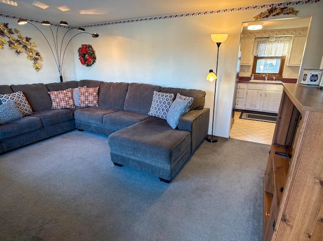 carpeted living room with sink