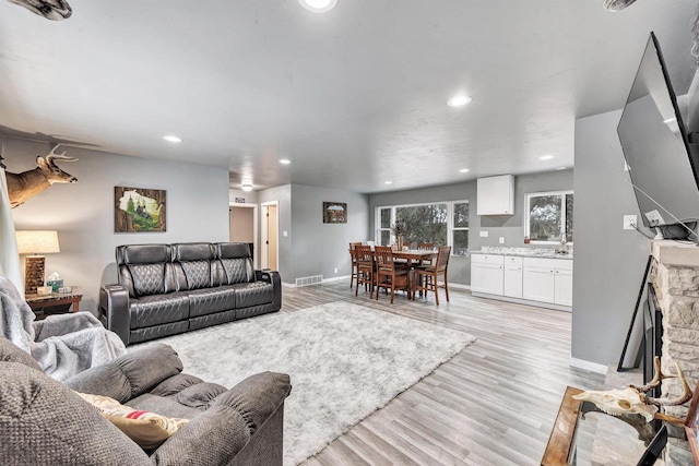 living room with a fireplace and light hardwood / wood-style floors