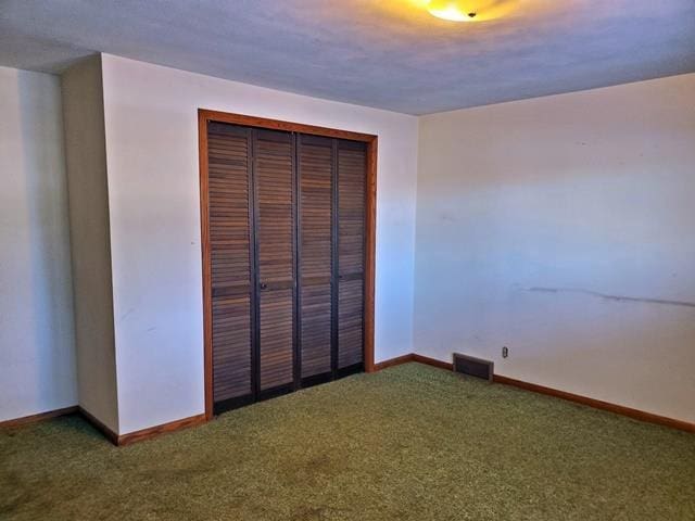 unfurnished bedroom featuring a closet and carpet floors