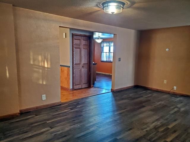 unfurnished room featuring dark hardwood / wood-style floors