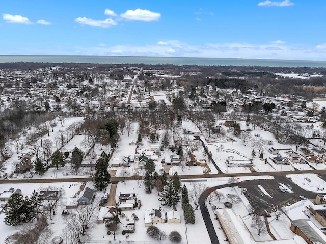 snowy aerial view with a water view