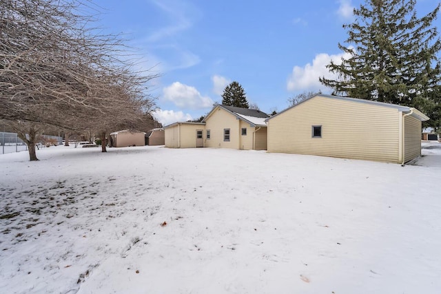 view of snow covered rear of property