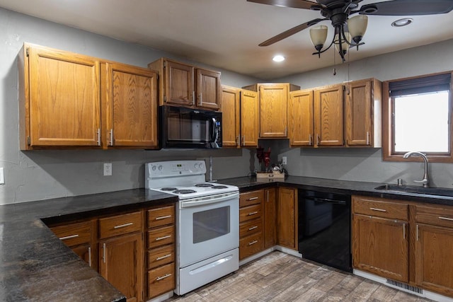 kitchen with hardwood / wood-style flooring, sink, black appliances, and ceiling fan