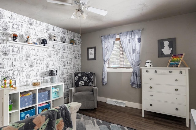 sitting room featuring ceiling fan and dark hardwood / wood-style flooring