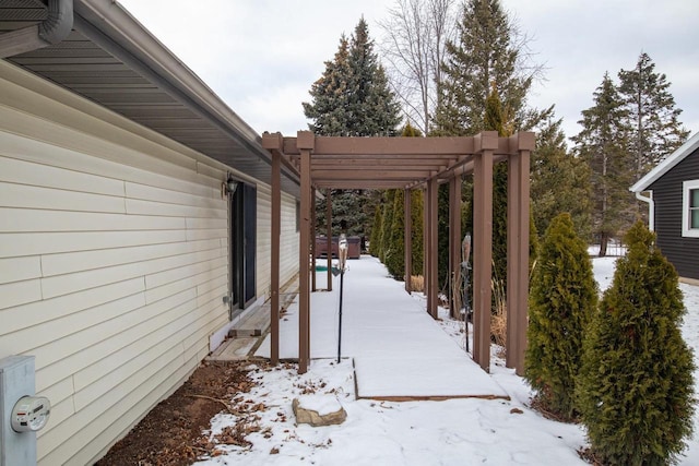 view of snowy exterior featuring a pergola