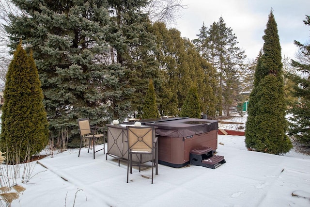 yard layered in snow featuring a hot tub