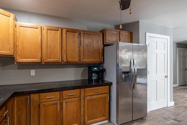 kitchen with wood-type flooring and stainless steel fridge with ice dispenser