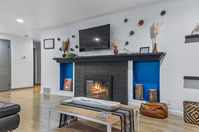 living room with a fireplace and hardwood / wood-style floors