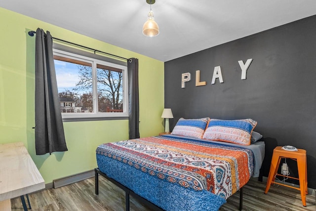 bedroom with hardwood / wood-style flooring and a baseboard radiator