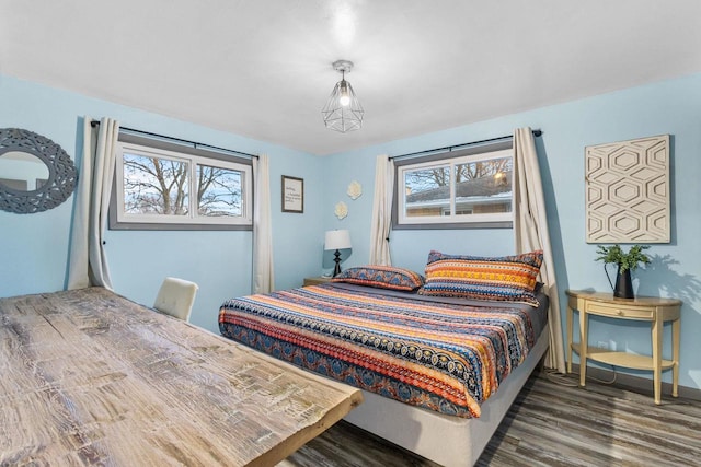 bedroom with dark hardwood / wood-style flooring