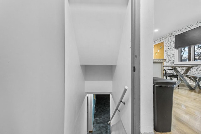 staircase with hardwood / wood-style floors